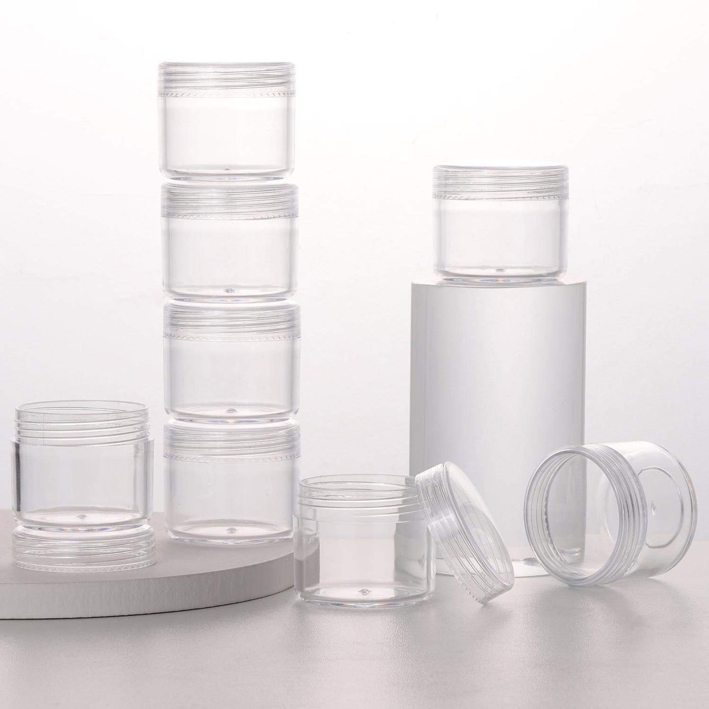 Refillable Cosmetic Sample Jars - 100 Pack 20g (0.7oz) Clear Small Travel Containers with Lids + 10 Mini Makeup Spatulas - BPA Free